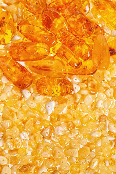Yellow amber stones closeup lie on a flat surface. — Stock Photo, Image