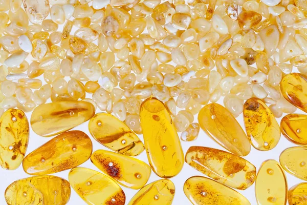 Yellow amber stones on a white background. — Stock Photo, Image