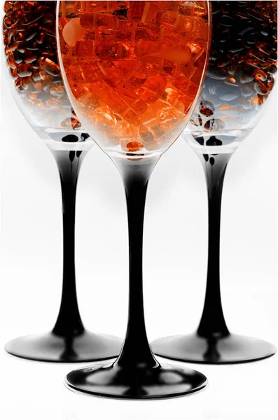 Yellow amber stones inside a transparent glass for wine. — Stock Photo, Image