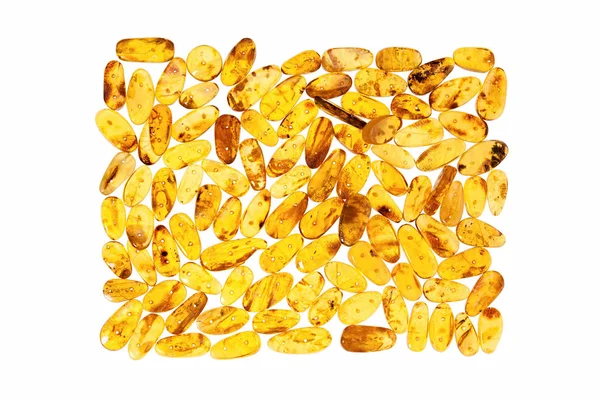 Yellow amber stones on a white background. — Stock Photo, Image