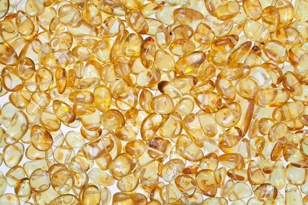 Yellow amber stones on a white background. — Stock Photo, Image