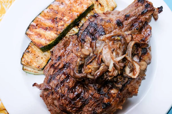 rib steak with grilled zucchini