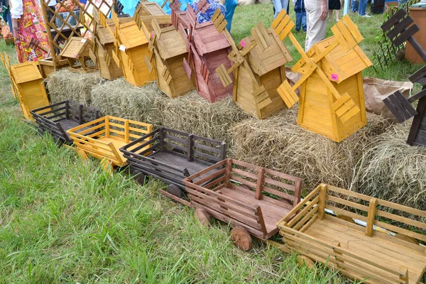 Sale of wooden models of windmills and vehicles at a fair of folk art — Stock Photo, Image