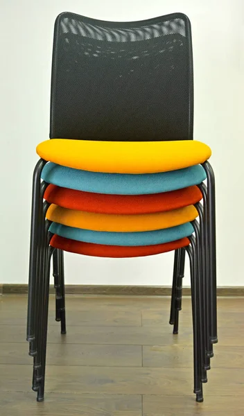 Office chairs are put with color semi-soft seats in a stack — Stock Photo, Image