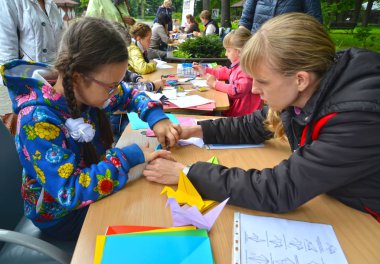 Kaliningrad, Rusya Federasyonu - 17 Eylül 2017: Origami koymak için kız öğretmen öğretir. Açık havada çocuk ana sınıfı