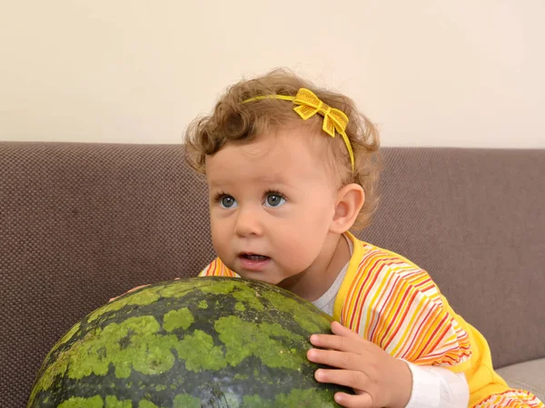 The little girl embraces hands big watermelon — Stock Photo, Image