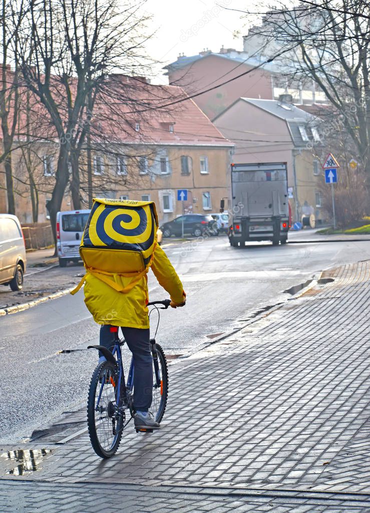 KALININGRAD, RUSSIA - DECEMBER 17, 2019: Courier of fast food delivery service 