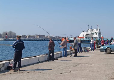 BALTIC, RUSSIA - APRIL 24, 2011: Catching herring in the sea channel. Kaliningrad region
