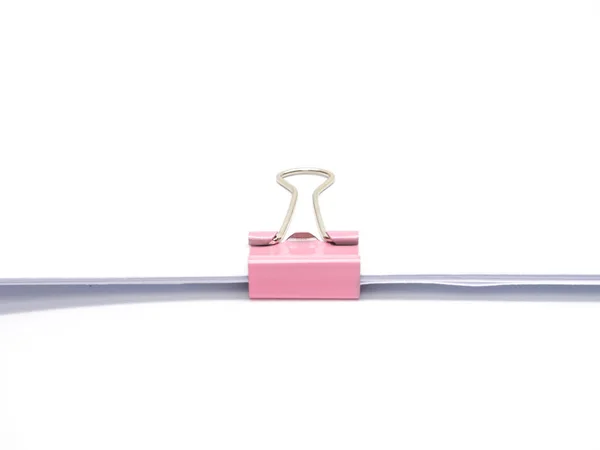 Pink paperclip attached on white paper isolated — Stock Photo, Image