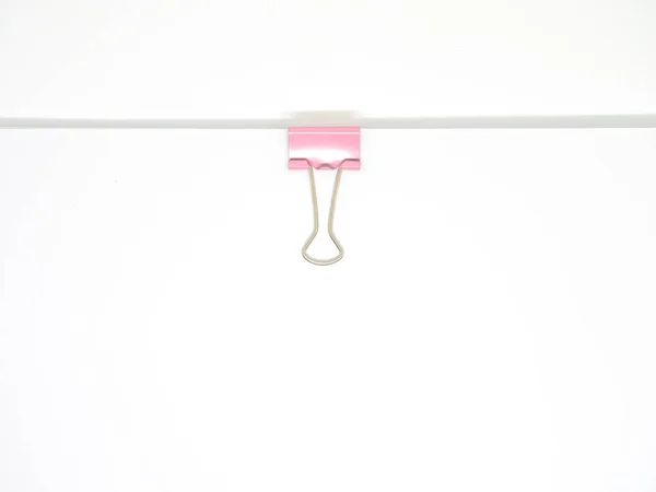 Pink paperclip attached on white paper isolated — Stock Photo, Image