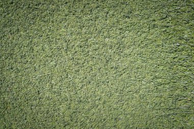 Sahte yeşil çim çim yüzey dokusunu arka plan