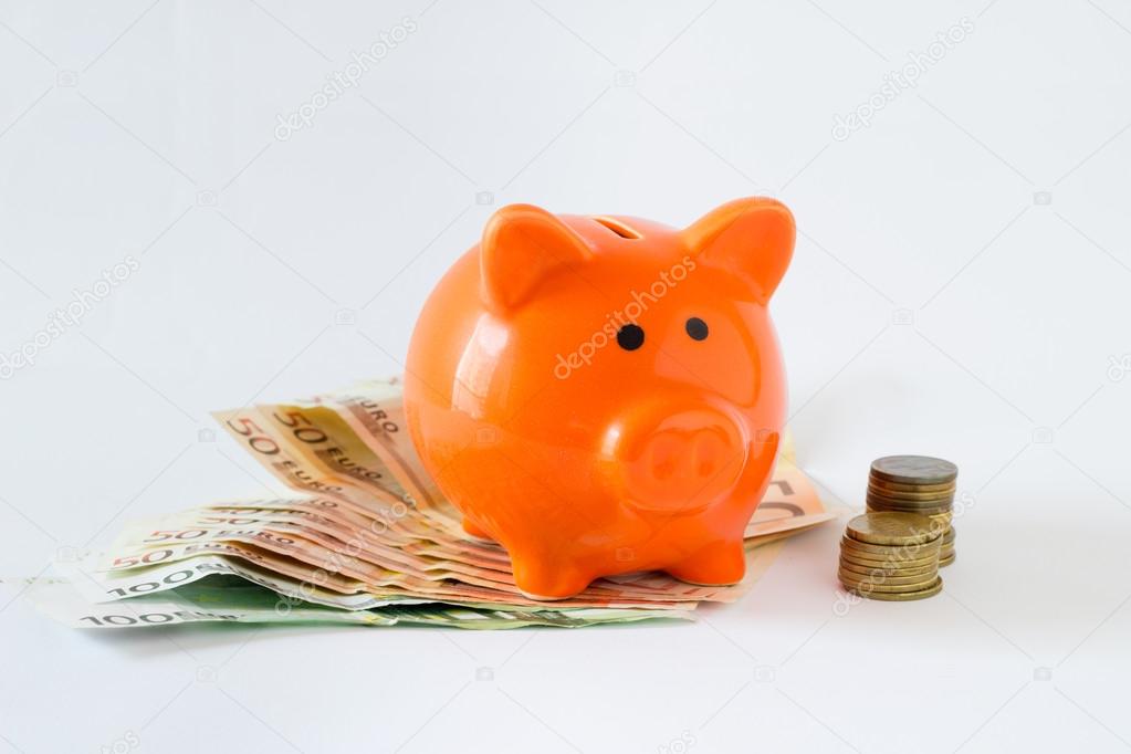 Pink piggy bank on money