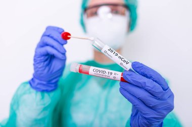 Hastane laboratuvarında COVID-19 burun temizleme testi, 2019 nCoV analizi için kan tüplü hemşire. Çin Koronavirüsü Kan Testi Konsepti.