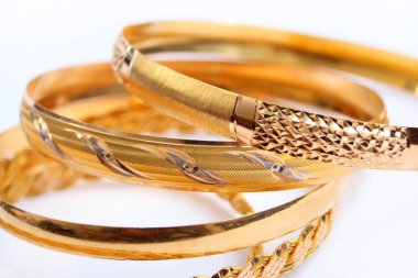 various gold bracelets on a white background clipart