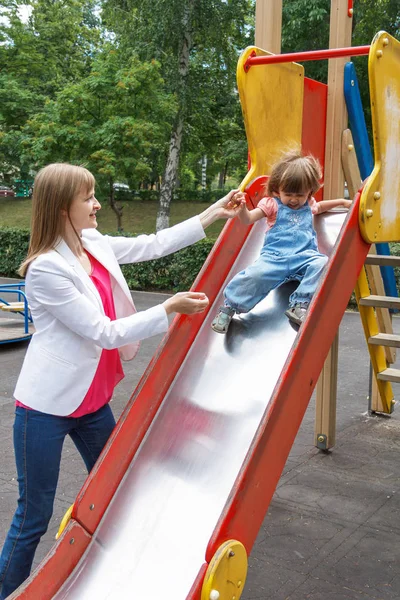 Girl riding at hutches with disheveled hair — Stock Photo, Image