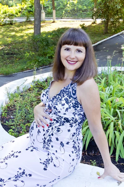 Smiling pregnant woman with brown hair — Stock Photo, Image