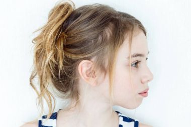 Cute girl with blond long hair in profile clipart