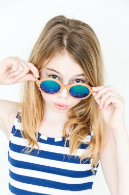 Cute blond girl with green sunglasses clipart