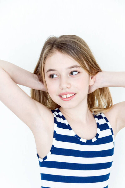 Cute girl playing with blond long hair standing