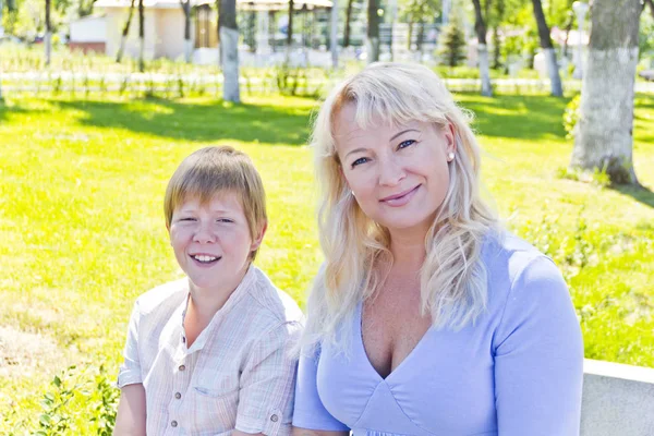 Blond woman and son smiling in the summer — Stock Photo, Image