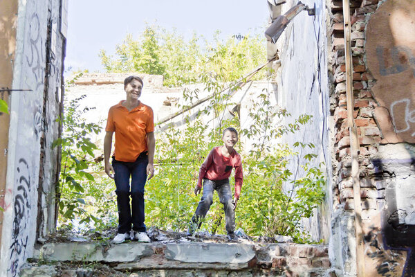 Father and son are playing through ruins
