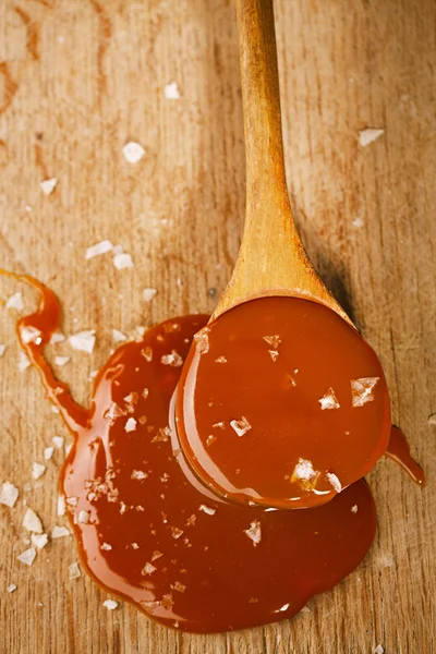 Salted caramel in spoon — Stock Photo, Image