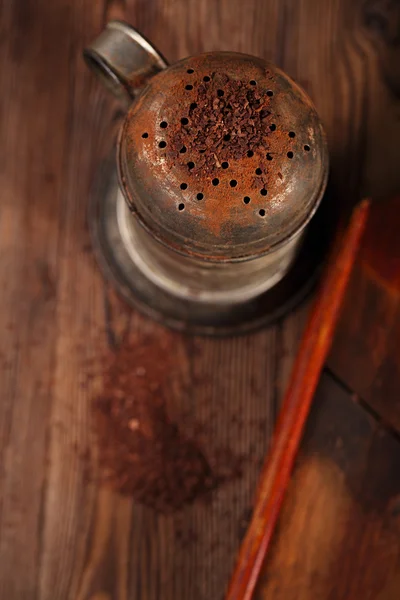 Vintage sifter with grated chocolate — Stock Photo, Image