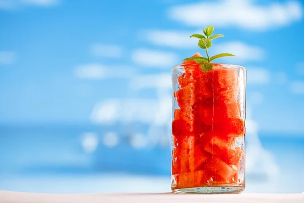 Watre melon in glass on beach — Stock Photo, Image