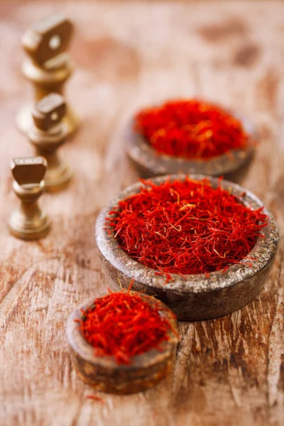 Saffron spice in antique iron bowls — Stock Photo, Image