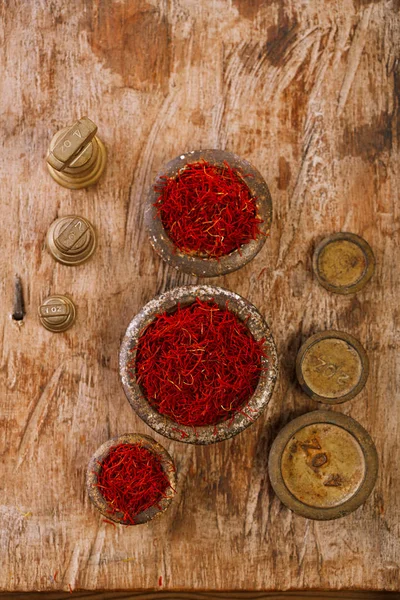 Saffron spice in antique iron bowls — Stock Photo, Image