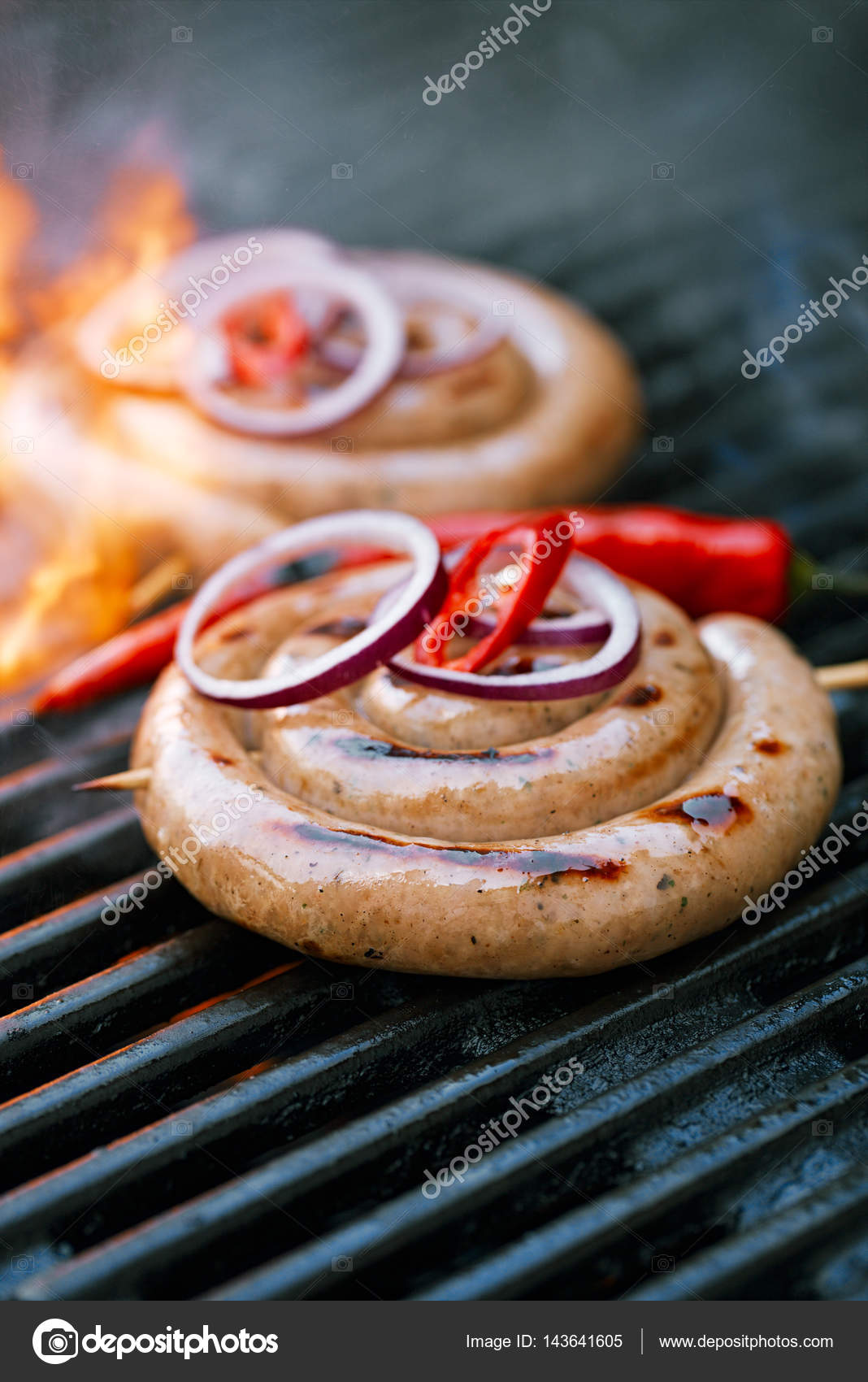Spiral pork sausages on bbq grill Stock Photo by ©lvenks 143641605