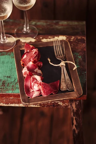 Cured Meat and vintage forks — Stock Photo, Image