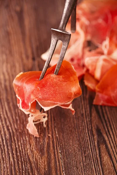 Spanish jamon on vintage fork — Stock Photo, Image