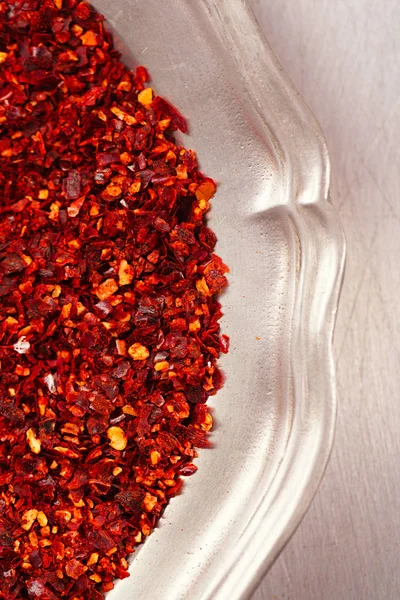 pile of harissa spice mix in metal tray, traditional Moroccan red hot chilli mix