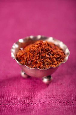 RAS el hanout, Fas, pembe kumaş üzerine küçük metal kapta geleneksel baharatlı karışım 