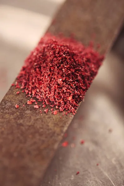 Ground Red Sumac Berries spice on knife — Stock Photo, Image
