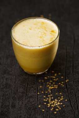 Cam ahşap masa üzerinde köpük üzerine parlak yıldız ile latte, yakın çekim