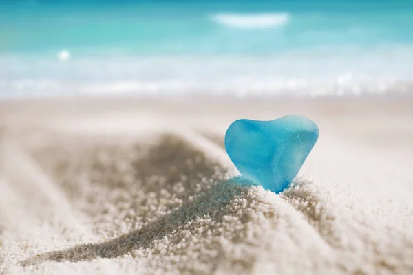 Sea glass blue heart on white sand beach — ストック写真