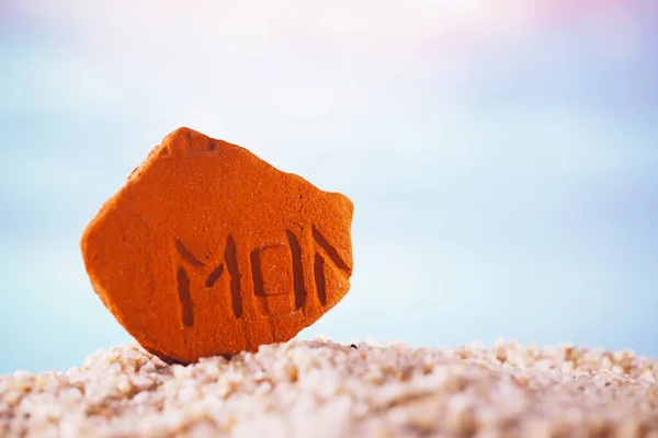 Sea stone  on  beach sand — Stock Photo, Image