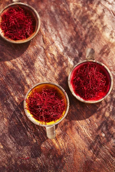 Saffron threads  in vintage dishes — Stock Photo, Image