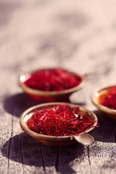 Saffron threads  in vintage dishes — Stock Photo, Image