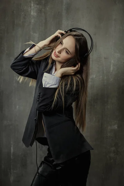 Sexy girl in classic jacket and shirt with headphones on his hea — Stock Photo, Image