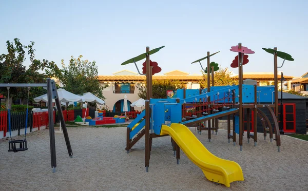 Playground with slide and swing at dawn — Stock Photo, Image