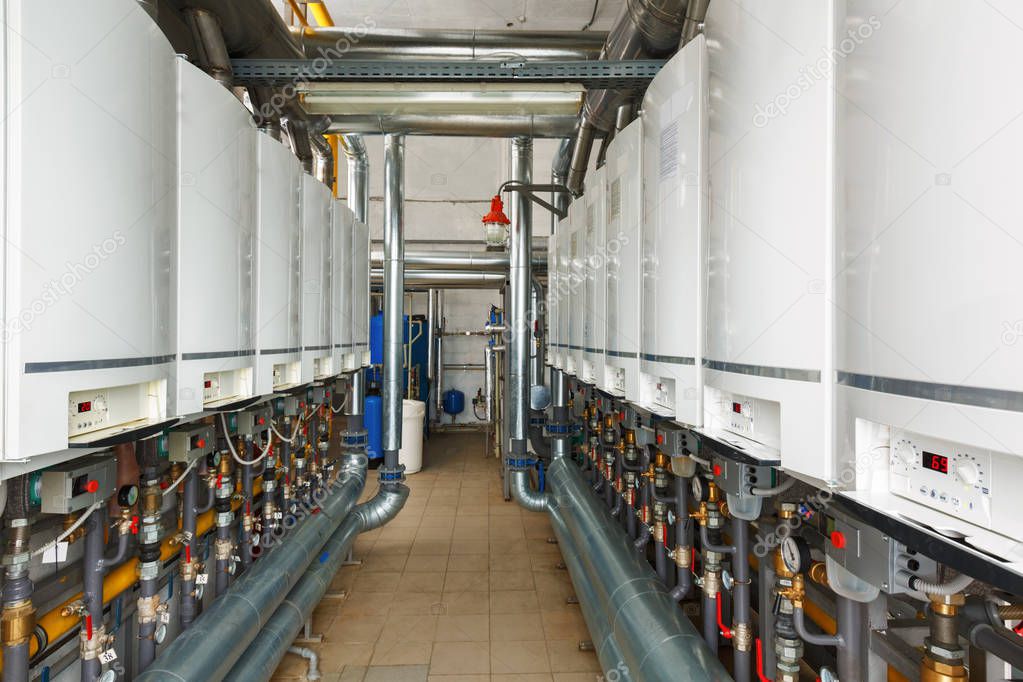 Interior of industrial, gas boiler house with a lot of boilers a