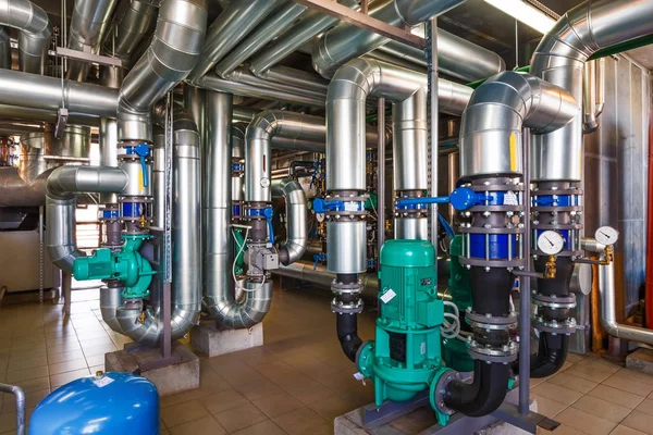 The interior of a modern gas boiler house with pumps, valves, a — Stock Image The interior of a modern gas boiler house with pumps, valves, a Stock Photo