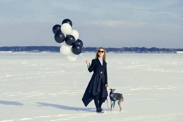 A woman with balloons and a dog of the Italian Greyhound breed h — Stock Photo, Image