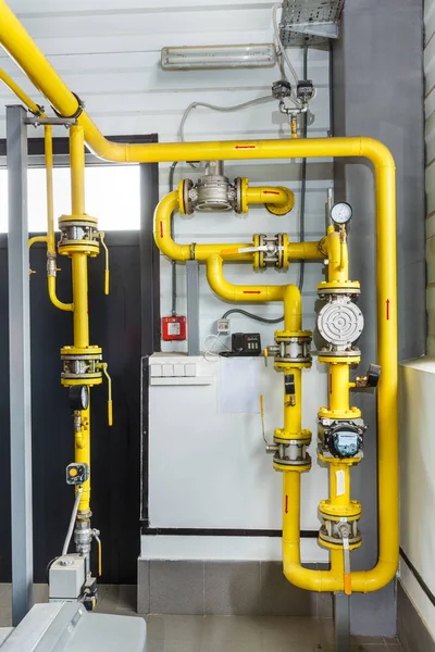 A lot of gas pipes and a gas meter in an industrial room — Stock Photo, Image