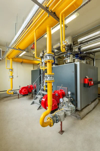 interior of an industrial gas boiler room with boilers and pipelines.