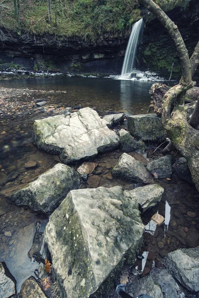 Beautiful cross processed waterfall landscape image in forest du — Stock Photo, Image