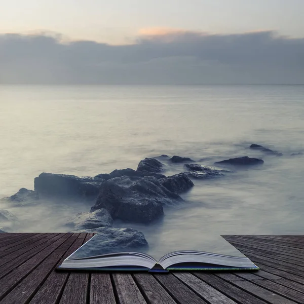 Peaceful cross processed landscape image of calm sea over rocks — Stock Photo, Image